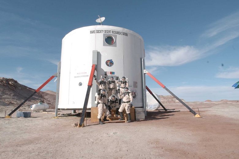 Photograph of the Mars Desert Research Station habitat structure, a white cylindrical two-story building set against the red Utah desert landscape